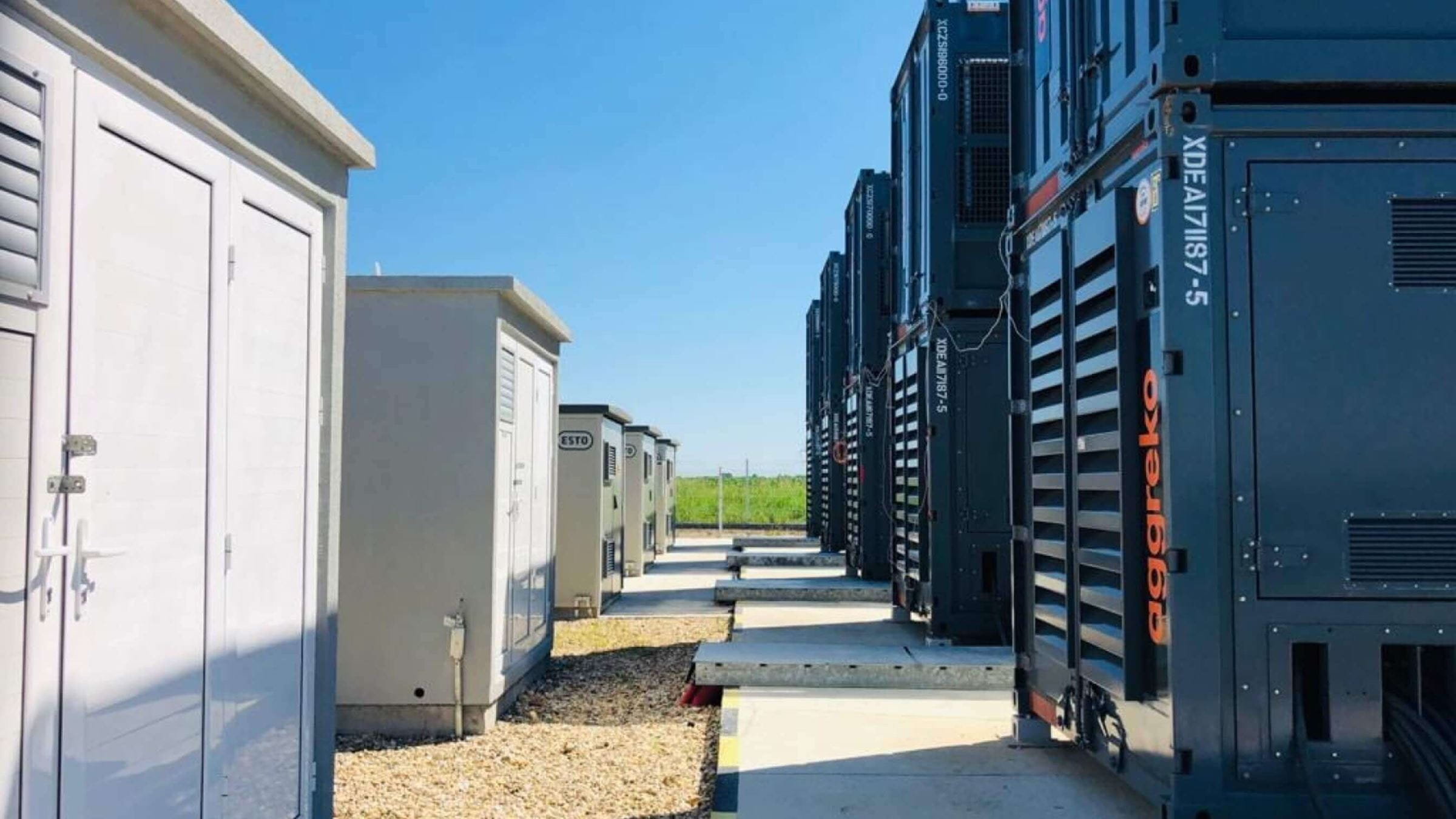 Row of generators with containers outside them 