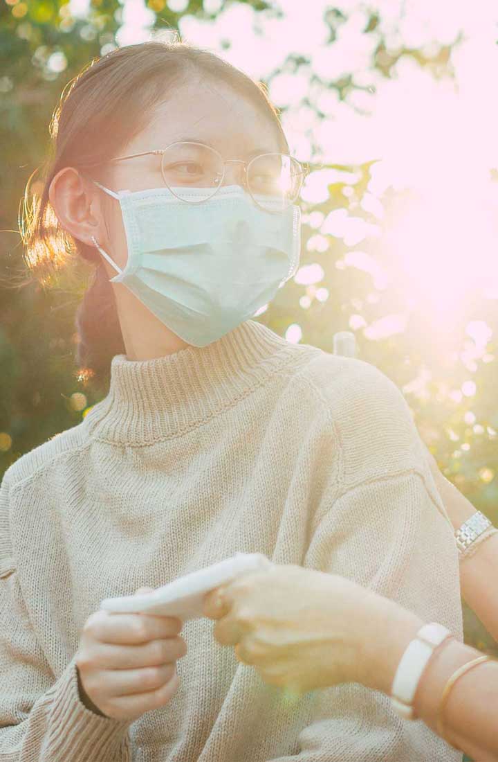 A lady wearing a mask in the countryside